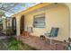 Relaxing front porch with terracotta tile and two chairs at 315 Palm Grove Ave, Englewood, FL 34223