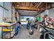 Overcrowded garage with motorcycle, tools, and various items at 315 Palm Grove Ave, Englewood, FL 34223