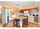 Bright kitchen features granite island with seating and opens to outdoor patio at 315 Palm Grove Ave, Englewood, FL 34223