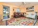 Spacious living room with comfy leather furniture and large area rug at 315 Palm Grove Ave, Englewood, FL 34223