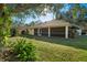 Back exterior of house with screened porch and mature landscaping at 3298 Branch Creek Dr, Sarasota, FL 34235