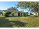 Back exterior view of house with screened porch and lush landscaping at 3298 Branch Creek Dr, Sarasota, FL 34235