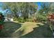 Large backyard with mature trees and lush landscaping at 3298 Branch Creek Dr, Sarasota, FL 34235