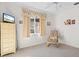 Bright bedroom with window, dresser, and armchair at 3298 Branch Creek Dr, Sarasota, FL 34235