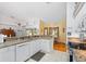 Galley kitchen with granite countertops and white cabinets at 3298 Branch Creek Dr, Sarasota, FL 34235