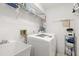 Laundry room with washer, dryer, and shelving at 3298 Branch Creek Dr, Sarasota, FL 34235