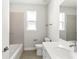 Modern bathroom with tub, toilet and vanity at 3411 Dryden St, North Port, FL 34288