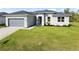 One-story home with gray siding, gray roof, and landscaping at 3411 Dryden St, North Port, FL 34288