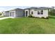 One-story home with gray siding, gray roof, and landscaping at 3411 Dryden St, North Port, FL 34288