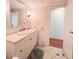 Clean bathroom with white vanity, large mirror, and tiled floor at 3411 Spanish Oak Ter, Sarasota, FL 34237