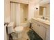 Bathroom with shower/tub combo, white vanity, and toilet at 3411 Spanish Oak Ter, Sarasota, FL 34237