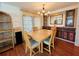 Dining room with wood-toned table and chairs, built-in hutch, and hardwood floors at 3411 Spanish Oak Ter, Sarasota, FL 34237