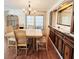 Bright dining area features a wood table and chairs, built in hutch and hardwood floors at 3411 Spanish Oak Ter, Sarasota, FL 34237