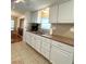 White cabinets and a neutral countertop highlight this well-lit kitchen at 3411 Spanish Oak Ter, Sarasota, FL 34237