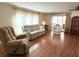 Living room with hardwood floors and comfy seating at 3411 Spanish Oak Ter, Sarasota, FL 34237