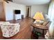 Living room with hardwood floors and a TV at 3411 Spanish Oak Ter, Sarasota, FL 34237