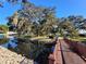 Wooden footbridge leads across a calm canal, offering scenic waterfront views at 3411 Spanish Oak Ter, Sarasota, FL 34237