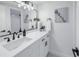 Updated bathroom with white vanity, black accents, and a large mirror at 3640 41St S Ln # F, St Petersburg, FL 33711