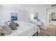 Main bedroom with king bed and coastal-themed artwork at 3640 41St S Ln # F, St Petersburg, FL 33711