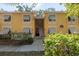 Condo building with yellow exterior and stairs at 3640 41St S Ln # F, St Petersburg, FL 33711