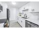 Updated kitchen featuring stainless steel appliances and white shaker cabinets at 3640 41St S Ln # F, St Petersburg, FL 33711