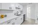 Modern white kitchen with stainless steel appliances and quartz countertops at 3640 41St S Ln # F, St Petersburg, FL 33711