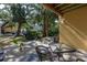 Small patio with table and chairs, shaded by trees at 3640 41St S Ln # F, St Petersburg, FL 33711