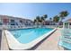 Community pool with plenty of lounge chairs at 3640 41St S Ln # F, St Petersburg, FL 33711