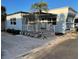 Light blue mobile home with covered porch and palm tree at 3710 Gulf Of Mexico Dr # G-6, Longboat Key, FL 34228