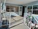 Covered porch with white railing and access to the mobile home at 3710 Gulf Of Mexico Dr # G-6, Longboat Key, FL 34228