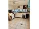 Small kitchen with white cabinets and appliances needing updating at 3710 Gulf Of Mexico Dr # G-6, Longboat Key, FL 34228