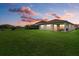 Backyard patio at sunset with lake view at 3713 Savanna Palms Ct, Bradenton, FL 34211