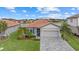 One-story home with tile roof, landscaped yard, and two-car garage at 3713 Savanna Palms Ct, Bradenton, FL 34211