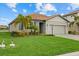 One-story home with gray siding, tile roof, and landscaped lawn at 3713 Savanna Palms Ct, Bradenton, FL 34211