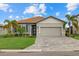 Charming one-story home with a gray garage and landscaping at 3713 Savanna Palms Ct, Bradenton, FL 34211