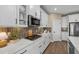 Modern kitchen with white cabinets, stainless steel appliances, and quartz countertops at 3713 Savanna Palms Ct, Bradenton, FL 34211