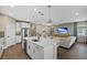 Modern kitchen with white cabinetry, large island, and stainless steel appliances at 3713 Savanna Palms Ct, Bradenton, FL 34211