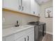 Bright laundry room featuring modern washer, dryer, and cabinets at 3713 Savanna Palms Ct, Bradenton, FL 34211