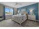 Bright bedroom with water view, and calming blue accent wall at 3713 Savanna Palms Ct, Bradenton, FL 34211