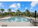 Inviting community pool with lounge chairs and tables at 3713 Savanna Palms Ct, Bradenton, FL 34211