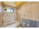 Bathroom features a bathtub with shower and a window, with a partially renovated wall, poised for customization at 3810 Gulf Of Mexico Dr # F105, Longboat Key, FL 34228