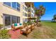 A furnished patio offers a relaxing outdoor space with serene waterfront views at 3810 Gulf Of Mexico Dr # F105, Longboat Key, FL 34228