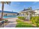 Tranquil pool area with seating and shade, blending relaxation and community amenities, enhanced by green landscaping at 3810 Gulf Of Mexico Dr # F105, Longboat Key, FL 34228