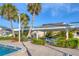 Inviting poolside area with shade structure, seating, and lush greenery, perfect for relaxation and community gatherings at 3810 Gulf Of Mexico Dr # F105, Longboat Key, FL 34228