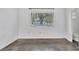 Simple bedroom with large window and polished concrete floors at 3904 Lakeside Rd # 174, Sarasota, FL 34232