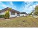 Exterior view showing contemporary home with lawn and white fence at 3904 Lakeside Rd # 174, Sarasota, FL 34232