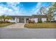 White exterior condo with carport and landscaping at 3904 Lakeside Rd # 174, Sarasota, FL 34232