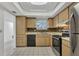 Galley style kitchen with wood cabinets and tile floors at 3904 Lakeside Rd # 174, Sarasota, FL 34232