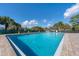 Community pool with lounge chairs and surrounding landscape at 3904 Lakeside Rd # 174, Sarasota, FL 34232