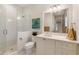 Modern bathroom with a glass shower, white cabinets, and a large mirror at 3930 Red Rock Way, Sarasota, FL 34231